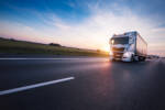 Loaded European truck on motorway in sunset