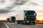 Fleet,Trucks,On,A,Country,Highway,Under,An,Sunset,Sky.